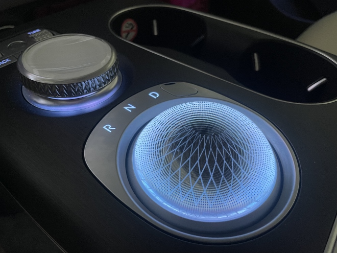Genesis GV60 Test und Kaufberatung: Bedienung der Automatik, Schalthebel und Drehschalter auf der Mittelkonsole leuchtend bei Dunkelheit